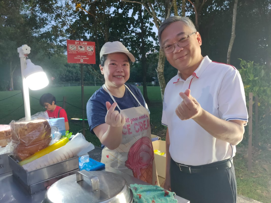 Happy customer and staff member at outdoor park event