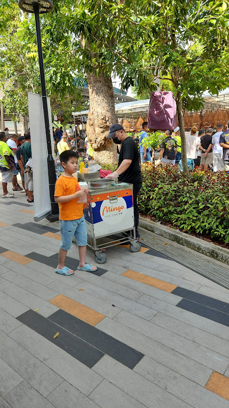 Young customer enjoying ice cream at public plaza event