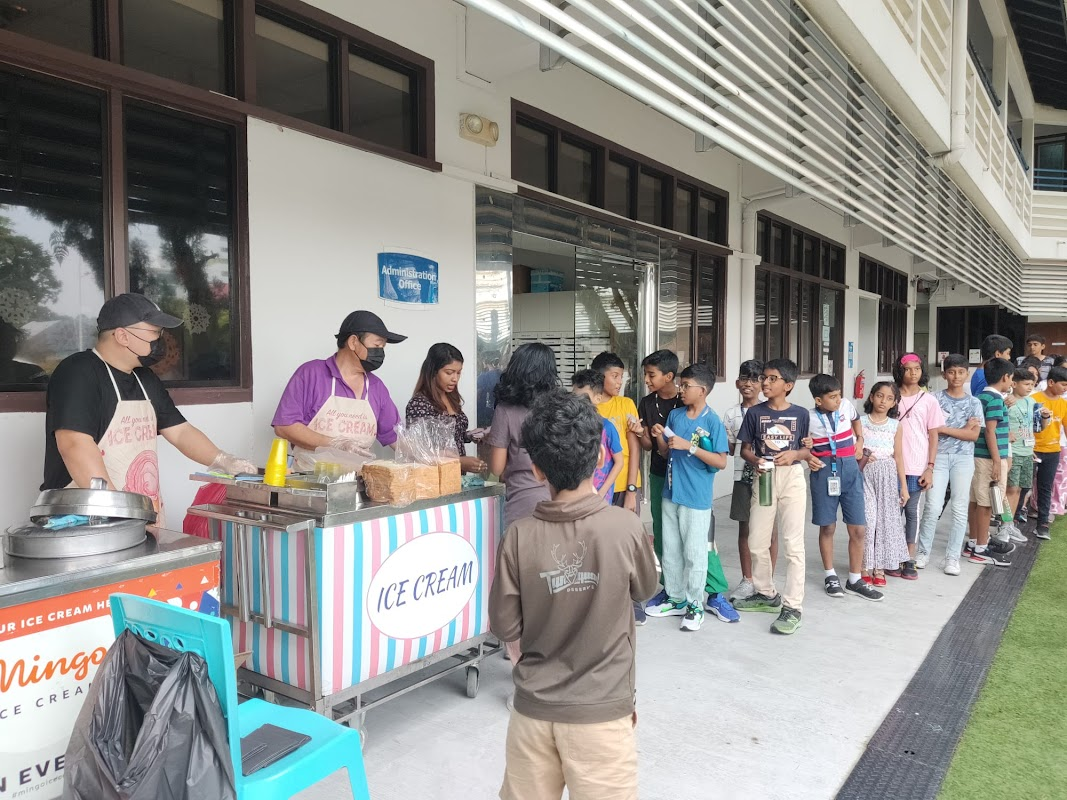 School children queuing for ice cream service